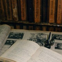 Clifton School's original diary and logbook, pictured set against a backdrop of memorabilia from that era.