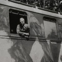 Following his liberation from the notorious Auschwitz Nazi death camp, Roman is transported to safety aboard an Allied Forces camouflaged train carriage during 1945.